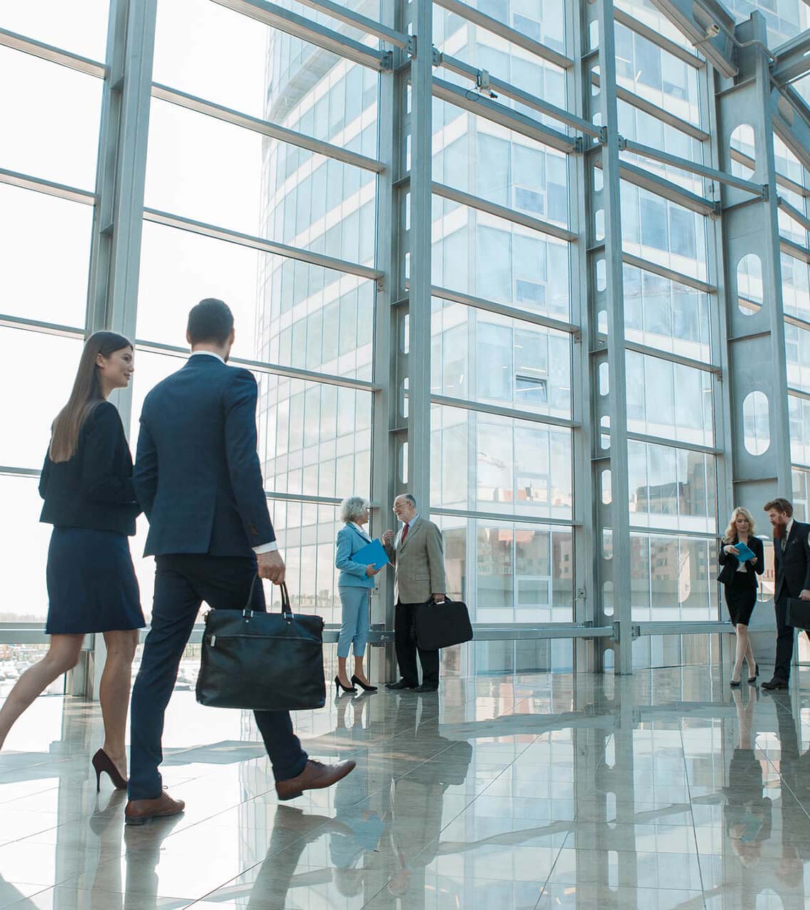 business people walking in glass building